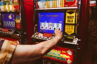 A local gambler plays simultaneously on two coin slot machines after winning a big jackpot at El Cortez Casino, Wednesday, Oct. 2, 2019.
