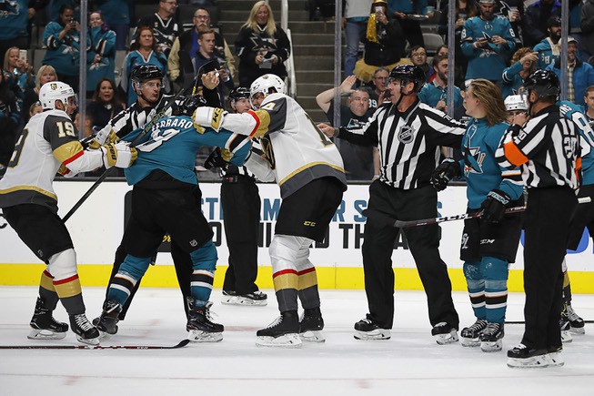 Officials try to stop a multi-player fight between the Vegas ...