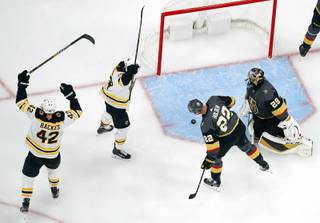 Bruins' David Backes (42) and Chris Wagner celebrate after Torey Krug scored against the Vegas Golden Knights during the second period of an NHL hockey game Tuesday, Oct. 8, 2019, in Las Vegas.
