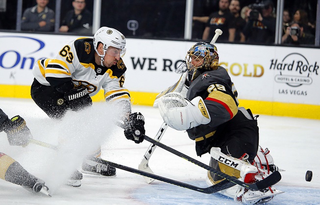 Boston Bruins center Brad Marchand (63) attempts a shot on ...