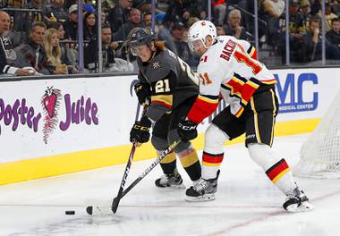 Golden Knights center Cody Eakin fights for the puck against Calgary center Mikael Backlund at T-Mobile Arena Saturday, Oct. 12, 2019.