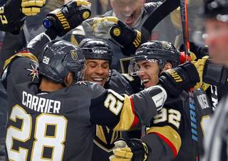 Vegas Golden Knights right wing Ryan Reaves, center, is congratulated by teammates William Carrier (28) and Tomas Nosek (92) after scoring during the third period of a game at T-Mobile Arena Saturday, Oct. 12, 2019.