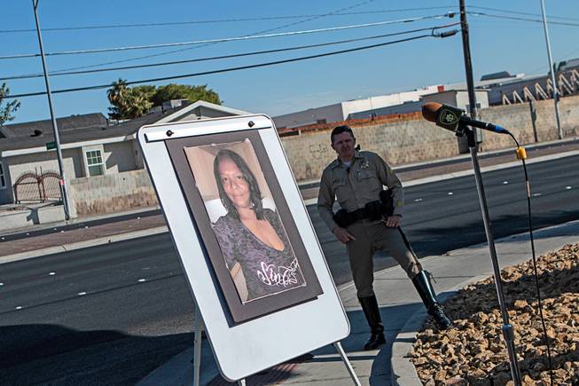 A photo of Jacqueline Dillon fronts a Metro Police officer on a sidewalk near Charleston and Nellis boulevards, near where she was killed by a hit-and-run driver on April 3. 