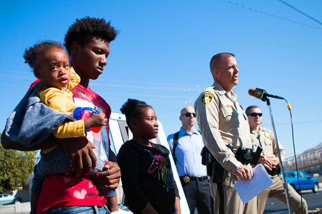 Metro Police Lt. Greg Munson, next to three of Jacqueline Dillon's grandchildren, addresses the media on Oct. 14, 2019, near Charleston and Nellis boulevards, in the area where Dillon was killed by a hit-and-run driver on April 3. 
