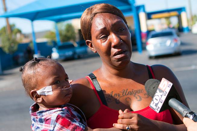 Airreyata Dillon holds her baby while speaking to reporters on Monday, Oct. 14, 2019, about her mother, Jacqueline Dillon, who was killed by a hit-and-run driver April 3 near Charleston and Nellis boulevards.