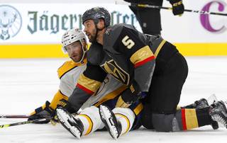 Vegas Golden Knights defenseman Deryk Engelland (5) gets off the ice after falling over Nashville Predators left wing Austin Watson (51) during the second period of a game at T-Mobile Arena Tuesday, Oct. 15, 2019.