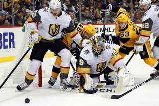 Vegas Golden Knights goaltender Marc-Andre Fleury (29), Jon Merrill (15) and Nick Holden (22) scramble for the puck as Pittsburgh Penguins' Teddy Blueger (53) and Zach Aston-Reese (46| watch it during the second period of an NHL hockey game, Saturday, Oct. 19, 2019, in Pittsburgh.