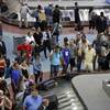In this June 29, 2018, file photo, passengers wait for baggage at McCarran International Airport in Las Vegas.