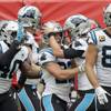 Carolina Panthers running back Christian McCaffrey (22) is congratulated by quarterback Kyle Allen after scoring a touchdown against the Tampa Bay Buccaneers during the first quarter of an NFL football game, Sunday, Oct. 13, 2019, at Tottenham Hotspur Stadium in London.