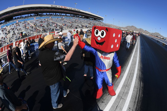 Las Vegas Motor Speedway mascot Pit Boss high-fives fans during ...