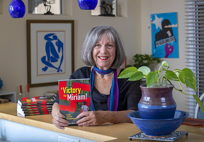 Author Joanne Gilbert holds her newest book 