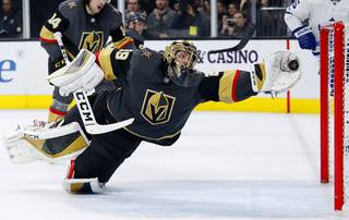 Golden Knights goaltender Marc-Andre Fleury dives to make a glove save against the Toronto Maple Leafs during the third period of an NHL hockey game Tuesday, Nov. 19, 2019, in Las Vegas. 