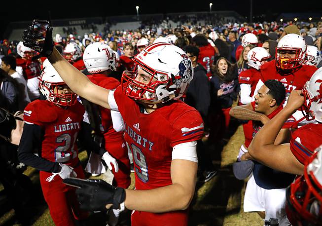 Liberty's Moliki Matavao (9) takes video on his phone as the team celebrates their 30-24 overtime victory over Bishop Gorman in the Desert Region championship at Liberty in Henderson Friday, Nov. 22, 2019. 