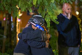 Sue Ann Cornwell, center, a survivor of the Oct. 1 mass shooting, gets a hug from Dylan Culwell during a Tree of Life lighting ceremony at the Las Vegas Community Healing Garden Tuesday, Nov. 26, 2019. Aaron Leifheit stands by  at right. This year's ceremony was dedicated to Kim Gervais. Gervais was injured in the Oct.1 mass shooting and passed away Nov. 1 of this year. 