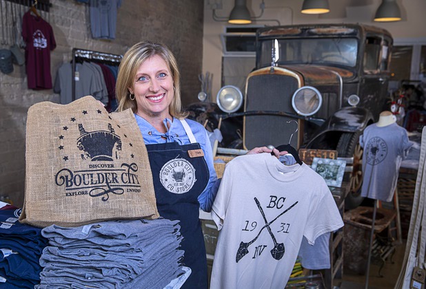 Tara Leon-Bertoli poses with Boulder City-themed merchandise in the Boulder City Company Store in Boulder City Wednesday, Nov. 27, 2019. Tara co-owns the business with her husband Dr. Troy Bertoli. In the background is her father's 1928 DeSoto sedan. 