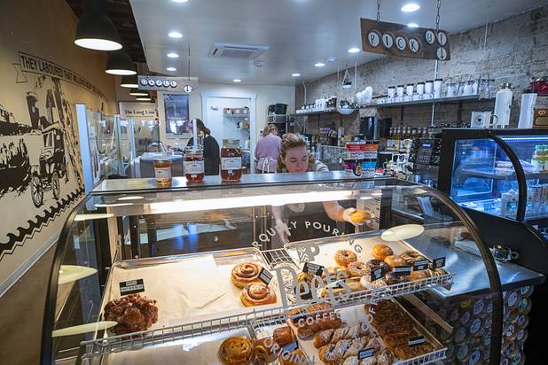 A worker restocks the display counter at Peet's Coffee, adjoining the Boulder City Company Store, after the morning rush in Boulder City Wednesday, Nov. 27, 2019. 
