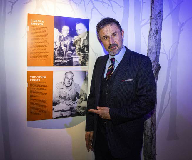 Actor David Arquette poses next to a photo of the ...