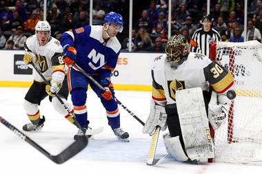 New York Islanders center Derick Brassard (10) watches as the puck glances off Vegas Golden Knights goaltender Malcolm Subban after the Islanders took a shot on him during the second period of an NHL hockey game, Thursday, Dec. 5, 2019, in Uniondale, N.Y. Golden Knights defenseman Nate Schmidt is at left rear. 