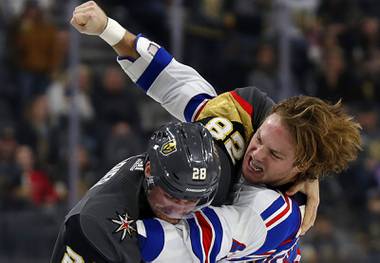 Vegas Golden Knights left wing William Carrier (28) and New York Rangers left wing Brendan Lemieux (48) fight during the third period of an NHL hockey game Sunday, Dec. 8, 2019, in Las Vegas.