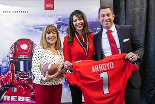 New UNLV football head coach Marcus Arroyo poses with UNLV President Marta Meana, left, and UNLV athletic director Desiree Reed-Francois, center, during an introductory news conference at the Fertitta Football Complex at UNLV Friday, Dec. 13, 2019.