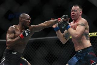 UFC welterweight champion Kamaru Usman lands a punch on Colby Covington in their welterweight title fight during UFC 245 at T-Mobile Arena Saturday, Dec. 14, 2019.
