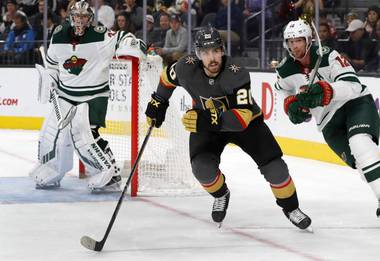 Vegas Golden Knights center Chandler Stephenson (20) chases after the puck with Minnesota Wild center Eric Staal (12) in the first period at T-Mobile Arena Tuesday, Dec. 17, 2019.