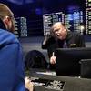 In this Nov. 18, 2019, photo, sportsbook shift manager Stuart Norsell, right, assists a patron, left, in the sports betting area of Twin River Casino in Lincoln, R.I.