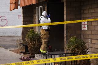 An official takes photos at the Alpine Motel Apartments where a fire killed 6 people last Saturday, Monday, Dec. 23, 2019.