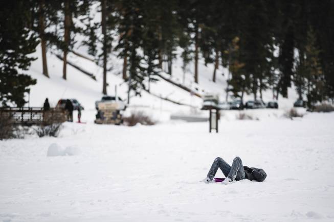 A man rests on a sled in Lee Meadows in the Spring Mountains Monday, Jan. 21, 2019.