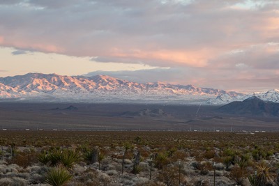 Snow covers the south McCullough Mountains as vehicles travel south along Interstate 15 towards Primm and the California border, Friday Dec. 27, 2019.