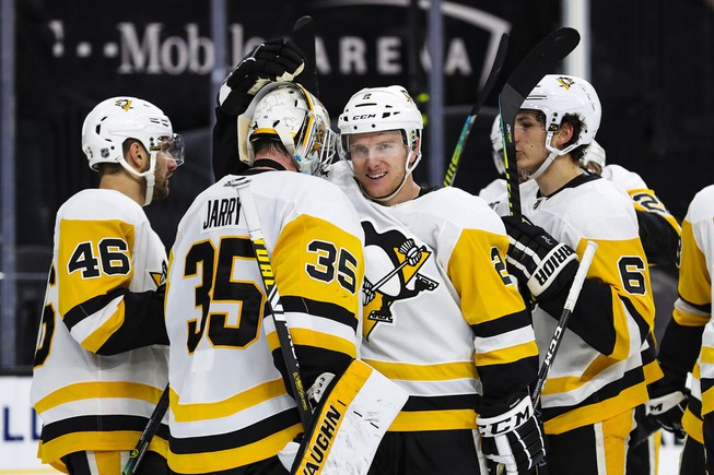 The Pittsburgh Penguins celebrate after beating the Vegas Golden Knights, ...