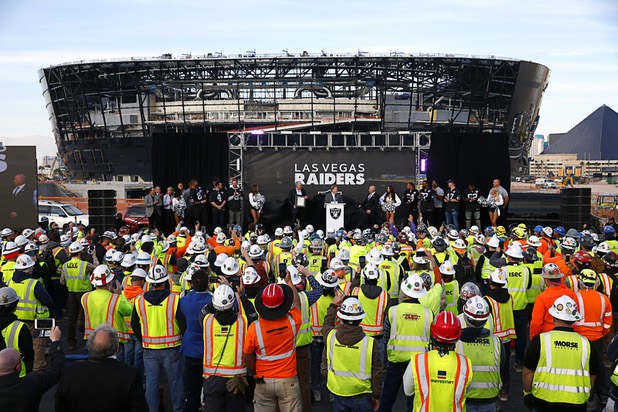 Las Vegas Raiders owner Mark Davis, center, speaks during a news conference, officially renaming the Oakland Raiders to the Las Vegas Raiders, in front of Allegiant Stadium Wednesday, Jan. 22, 2020.