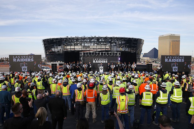 Las Vegas Raiders owner Mark Davis, center, speaks during a news conference, officially renaming the Oakland Raiders to the Las Vegas Raiders, in front of Allegiant Stadium Wednesday, Jan. 22, 2020.