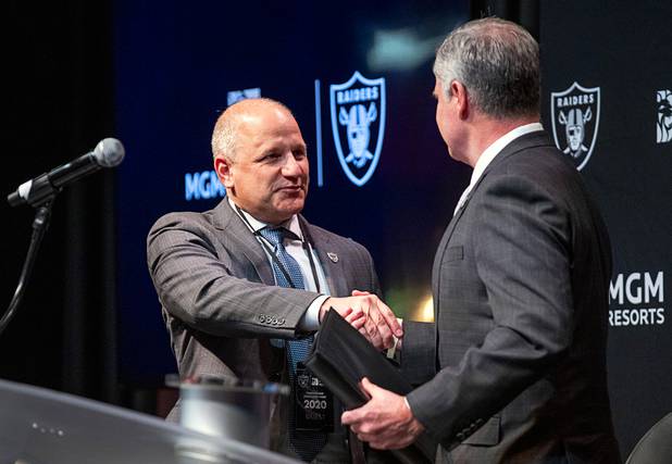 Marc Badain, left, president of the Las Vegas Raiders, is welcomed to the podium by Jim Murren, chairman and CEO of MGM Resorts International, during a news conference at Mandalay Bay Thursday, Jan. 23, 2020. MGM Resorts International announced a founding partnership with the Las Vegas Raiders.
