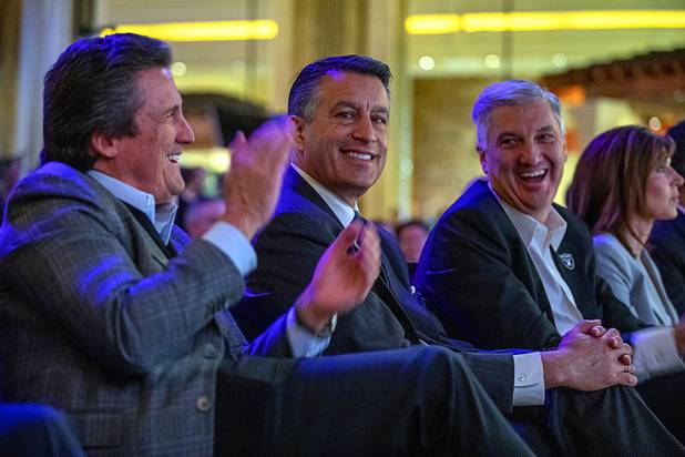 Former Nevada Governor Brian Sandoval, center, attends a news conference at Mandalay Bay Thursday, Jan. 23, 2020. MGM Resorts International announced a founding partnership with the Las Vegas Raiders. Sandoval is now president of global gaming development for MGM Resorts. At left is Bill Hornbuckle, president and COO of MGM Resorts.