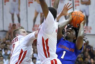Bishop Gorman's Will McClendon (1) takes a shot against Coronado's Jaxon Kohler (0) and Jaden Hardy (1) during a game at the Cox Pavilion at UNLV Friday, Jan. 24, 2020.