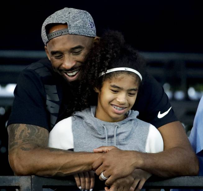 In this July 26, 2018 file photo former Los Angeles Laker Kobe Bryant and his daughter Gianna watch during the U.S. national championships swimming meet in Irvine, Calif. Bryant, the 18-time NBA All-Star who won five championships and became one of the greatest basketball players of his generation during a 20-year career with the Los Angeles Lakers, died in a helicopter crash Sunday, Jan. 26, 2020. Gianna also died in the crash. She was 13.

