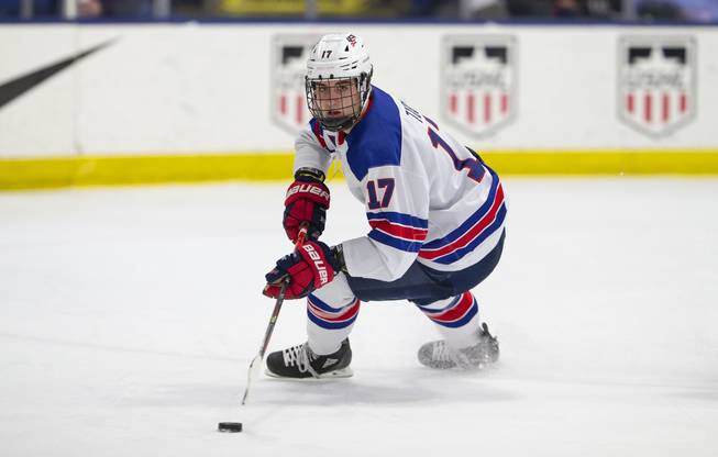 Forward Luke Tuch advances the puck while playing for the U.S. National Under-18 Team. 
