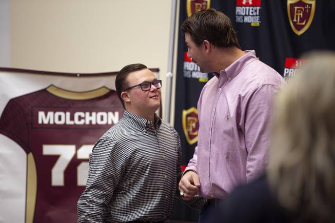 John Molchon, right, chats with a young fan during a meet & greet at Faith Lutheran high school, Monday, Jan. 27, 2020. Molchon, who helped the Crusaders win the 2013 state championship, is the first player to have his jersey returned. The offensive lineman recently concluded a celebrated four-year college career at Boise State, where he was a two-time first-team All-Mountain West selection and started 39 straight games to conclude his career. Hes expected to be a late-round selection in the upcoming NFL Draft.