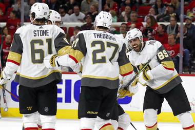 Golden Knights right wing Alex Tuch (89) celebrates with defenseman Shea Theodore (27) and right wing Mark Stone (61) following Tuch’s goal against the Carolina Hurricanes during the third period of an NHL hockey game in Raleigh, N.C., Friday, Jan. 31, 2020. 