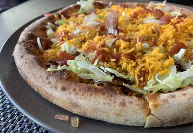 New bar food dishes include this taco pizza at Wolfgang Puck Players Locker.