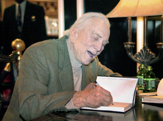 Actor Kirk Douglas greets fans and signs copies of his ...