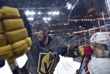 Vegas Golden Knights defenseman Brayden McNabb (3) and Carolina Hurricanes center Sebastian Aho (20) compete for the puck against the glass during the third period of an NHL hockey game Saturday, Feb. 8, 2020, in Las Vegas.