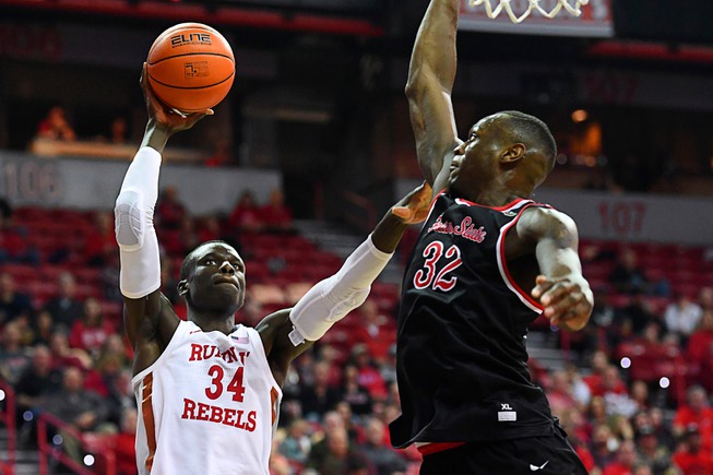 UNLV Rebels forward Cheikh Mbacke Diong (34) is defended by ...