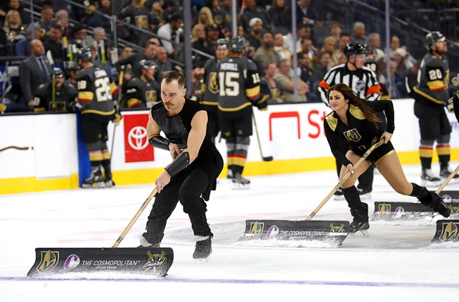 The Knights Guard cleans the ice during an NHL hockey ...