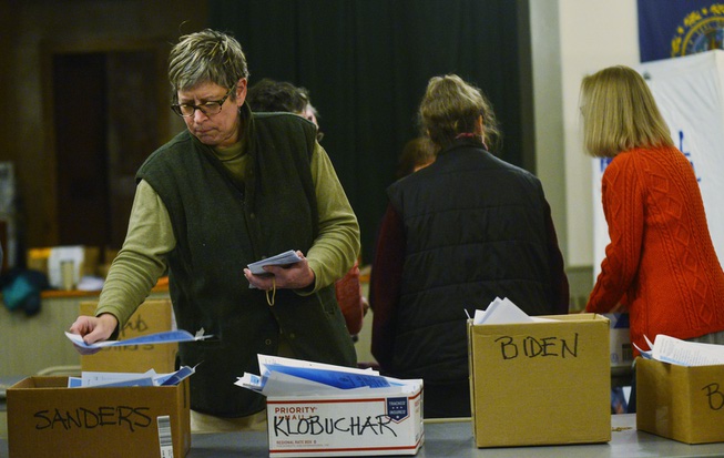 Margaret Halper places a primary ballot into a box after ...