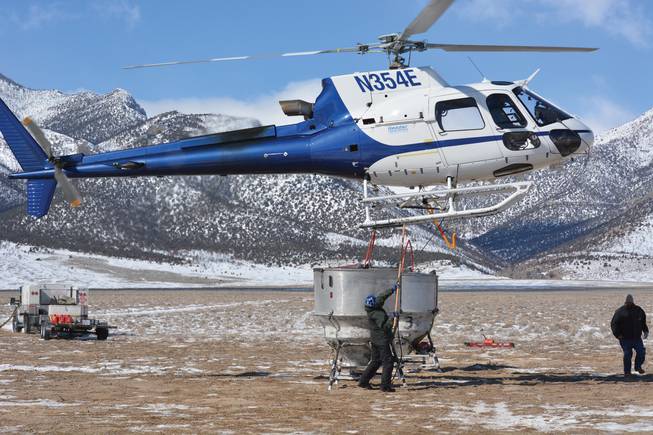 A helicopter is used in the reseeding process in the wake of the Goshute Cave Fire.