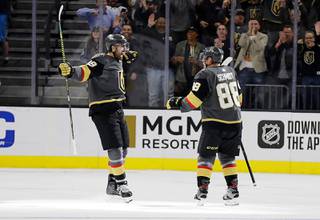 Vegas Golden Knights right wing Alex Tuch (89) and defenseman Nate Schmidt celebrate a Golden Knights score against the St. Louis Blues during the third period of an NHL hockey game Thursday, Feb. 13, 2020, in Las Vegas. Both players had goals in the period. The Golden Knights won 6-5 in overtime.