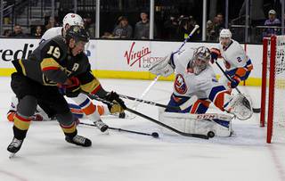 Vegas Golden Knights right wing Reilly Smith (19) shoots as New York Islanders goalie Semyon Varlamov defends during the second period of an NHL hockey game Saturday, Feb. 15, 2020, in Las Vegas.