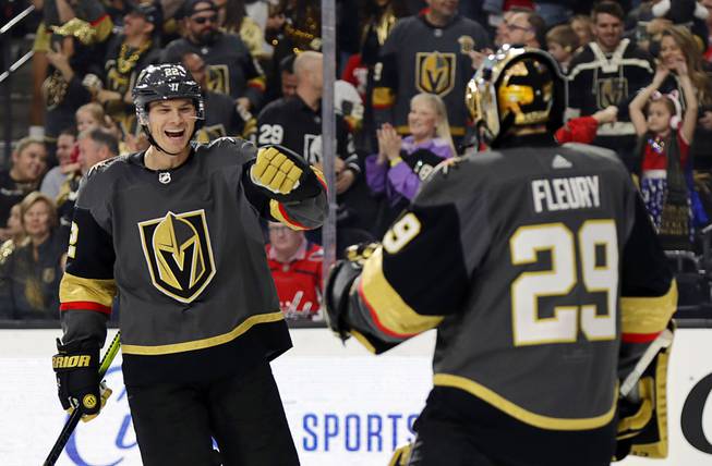 Vegas Golden Knights defenseman Nick Holden, Right, celebrates with goalie Marc-Andre Fleury after scoring against the Washington Capitals during the first period of an NHL hockey game Monday, Feb. 17, 2020, in Las Vegas.